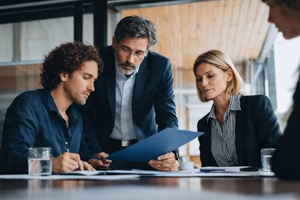 Echipă analizând documente pentru conformitate și protecția datelor la Hora Credit